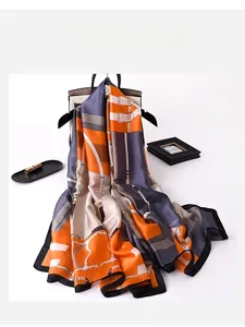 Detailed view of luxury chain pattern silk scarf draped on an elegant handbag