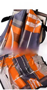 Detailed view of luxury chain and buckle silk scarf pattern with fine edge stitching