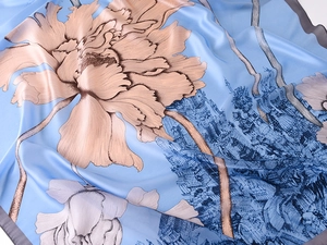 Detailed view of light blue silk scarf with floral and oriental architecture prints