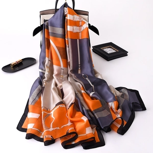 Detailed view of silk-feel scarf featuring classic equestrian harness patterns and buckles