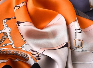Detailed view of luxury silk scarf with equestrian horse bit and chain patterns