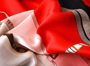 Macro shot of silk-like scarf featuring vintage belt patterns and elegant drape textures