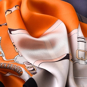 Elegant orange silk scarf with gold chain buckle and belt pattern in satin finish