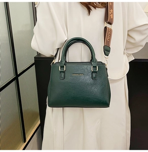 Detail of dark green tote bag featuring lychee texture and jacquard woven strap
