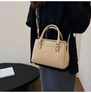 Chic beige tote bag with wide strap shown in a modern lifestyle setting with high-quality detail