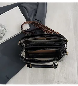 Interior view of black multi-compartment tote bag showing spacious storage for daily items