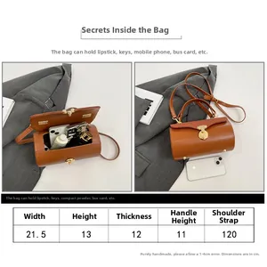 Detailed size chart for brown cylinder handbag with dimensions and shoulder strap info