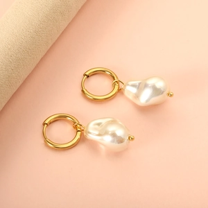 Close-up of irregular baroque pearl earrings with 18K gold plated stainless steel hoops