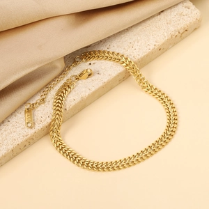 Elegantly coiled 18K gold plated stainless steel wheat chain bracelet with lobster clasp