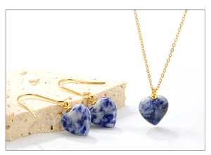 Detail view of heart-shaped natural blue marble necklace and earrings set with gold hooks