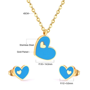 Detail of gold-plated stainless steel heart jewelry set with blue accents and measurements