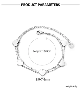 Macro view of double-layer stainless steel bracelet featuring five polished heart charms