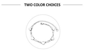 Detail of a double-layered stainless steel heart charm bracelet with lobster clasp closure