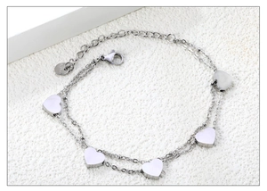 Detail of double-layer stainless steel heart bracelet with lobster clasp and extension chain