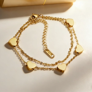 Double-layered 14K gold heart charm bracelet with lobster clasp and adjustable link chain
