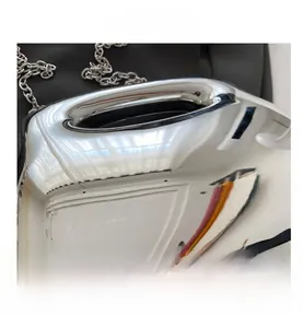 Close-up of shiny silver metallic acrylic mini bag with polished chain strap detail