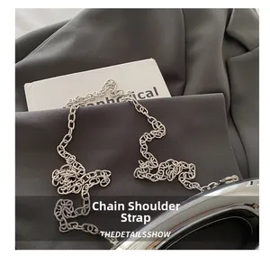 Close-up of a glossy silver metal chain shoulder strap for acrylic handbag detail