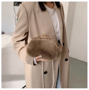 Detailed macro view of the soft brown faux fur texture and elegant pearl shoulder strap