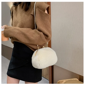 Winter plush shell bag featuring pearl strap and metal clasp shown on a shoulder model