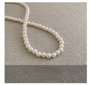 Detailed close-up of premium white faux pearl strap with elegant glossy finish