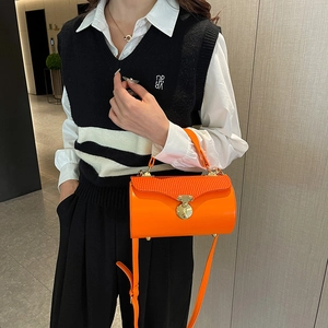 Chic orange cylindrical crossbody box bag with pleated texture and metal buckle handle