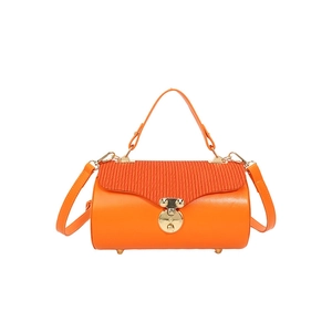 Orange cylinder bucket bag with textured leather flap and golden round buckle