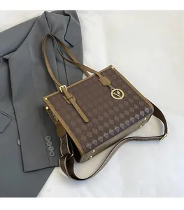 Detailed macro view of brown vintage patterned tote bag with metal logo and strap