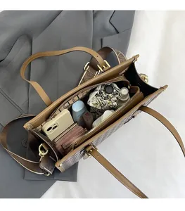 Detailed interior of vintage brown tote bag showing large capacity and multiple pockets