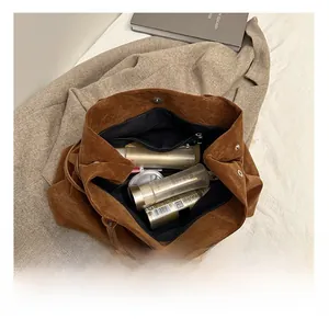 Interior view of brown faux suede tote bag showing large capacity and zipper pocket