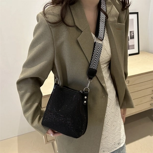 Black rhinestone bucket bag with wide geometric strap and sparkling finish