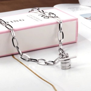 Silver stainless steel chunky chain necklace with toggle clasp on a magazine display