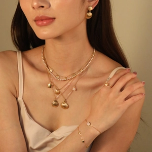 Elegant gold layered seashell necklace with pearls and matching earring set for women