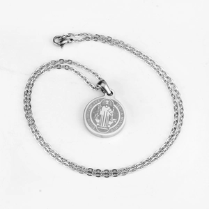 Detailed view of silver St. Benedict medal pendant with stainless steel cross chain
