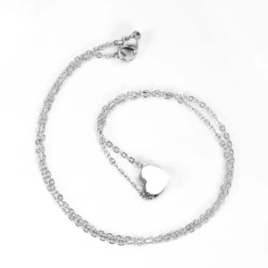 Polished stainless steel heart pendant necklace with elegant cross chain on white background
