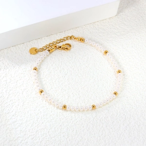 Minimalist stainless steel bracelet with alternating white pearls and gold metal beads