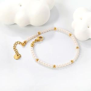 Minimalist pearl bracelet with gold stainless steel beads and lobster clasp closure