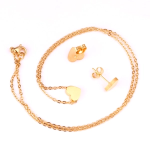 Minimalist gold heart jewelry set featuring a polished pendant necklace and matching studs