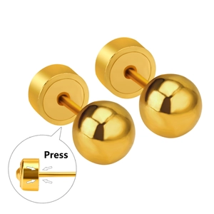 Detailed view of gold ball earrings with press-on flat back closure mechanism
