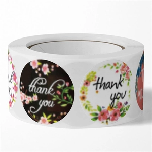 Macro side view of round floral Thank You stickers roll for wedding and gift packaging