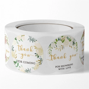 Roll of floral Thank You stickers with white flowers and gold text for wedding decor
