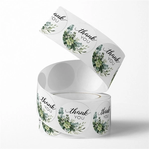 Roll of round floral thank you stickers with succulent and eucalyptus leaf wreath