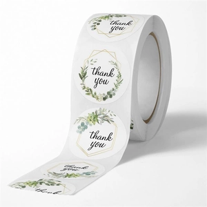 Detail view of round floral thank you stickers with eucalyptus leaves and gold frame