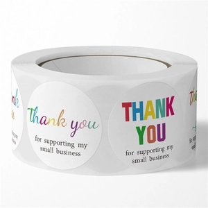 Close-up of a roll of colorful 'Thank You' stickers for packaging and gift decor