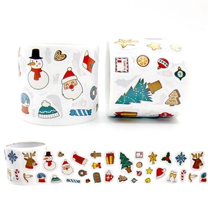 Detail of Christmas cartoon reward stickers roll featuring Santa Claus and reindeer designs