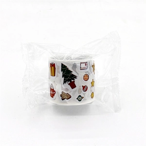 Roll of Christmas gift stickers featuring Santa letters, trees and gingerbread man motifs