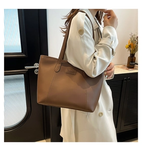 Brown leather tote bag featuring a Fashion label and sleek minimalist shoulder straps