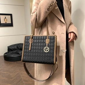 Vintage patterned large tote bag in black embossed leather with brown handles and gold logo