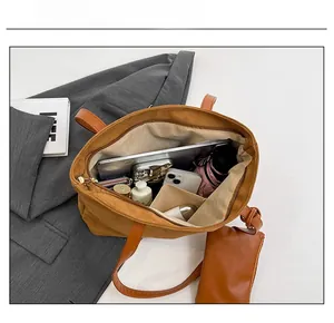 Brown suede tote bag interior showing ample storage for tablets and daily items