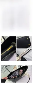 Detail of black pebbled leather tote with silk scarf handle and golden hardware accent