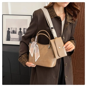 Dettaglio borsa shopper kaki goffrata con foulard floreale e ampia tracolla di tendenza